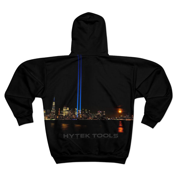The Hytek Tools NYC Unisex Zip Hoodie by Printify features a nighttime city skyline with twin blue light beams reflecting on the water, HYTEK TOOLS at the bottom, and a custom cut and sewn design for a perfect fit.