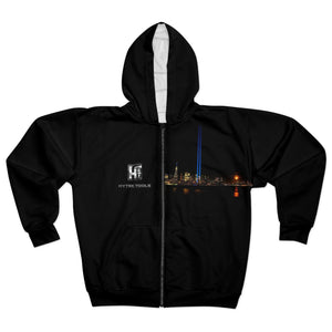 The Hytek Tools NYC Unisex Zip Hoodie by Printify is a black custom cut and sewn zip-up featuring a city skyline at night with two vertical blue lights. The design includes the skyline on the lower part and a small HYTEK TOOLS logo on the left chest for added style.