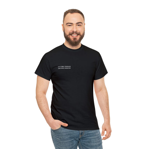 A smiling bearded man wears a classic fit black Unisex Heavy Cotton Tee by Printify, featuring premium printing, paired with blue jeans. He stands with one hand in his pocket against a plain white background.