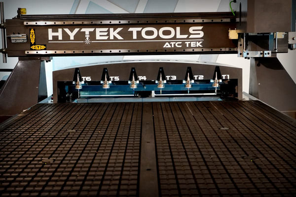 The 2024 ATCTEK™ CNC Industrial Router by Hytek Tools features a grid-patterned surface, includes an HSD spindle for enhanced performance, and has multiple toolheads labeled T1 to T6.