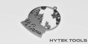 A snow globe ornament inscribed with Let it Snow, showcasing pine trees, a reindeer, and snowflakes is included in the Cut Ready DXF File Collection from the Holiday Ornaments Theme by Hytek Tools - Fiber Laser Sales - USA.