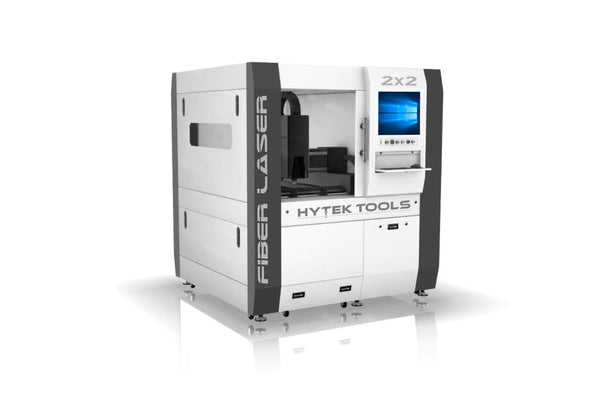 The Fiber Laser 2x2 by Hytek Tools is a large white industrial machine with black accents and a sleek design. It prominently features Fiber Laser and Hytek Tools, along with a display screen showing a Windows interface, reflecting advanced laser technology.