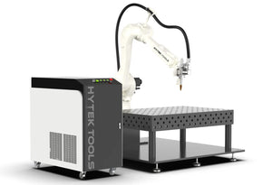 The BOTWELD™ 6 Axis Laser Welder by Hytek Tools features a white robotic arm on a metal perforated table with an IPG fiber laser, connecting to a black and white control unit labeled HYTEK TOOLS, ideal for precision tasks in manufacturing or machining.